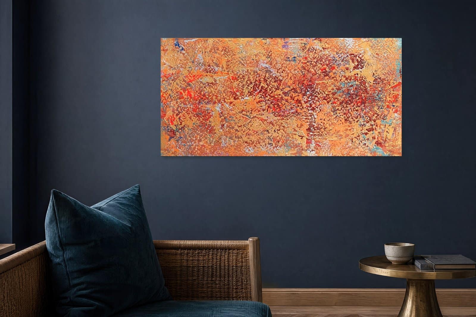 Embers orange gold abstract painting displayed above woven seating in a modern living room